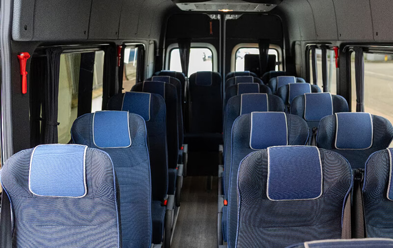 Ford Transit minibus cabin with blue and grey seats