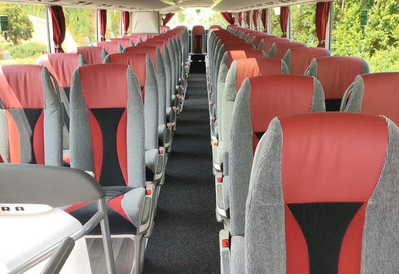 Aisle and red-and-grey seats in a Setra double-deck coach