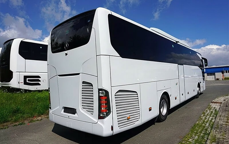White Mercedes-Benz Tourismo coach, rear three-quarter view